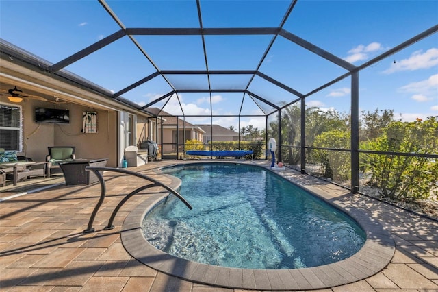 view of swimming pool featuring a lanai and a patio