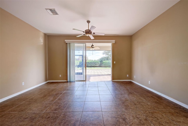 tiled spare room with ceiling fan