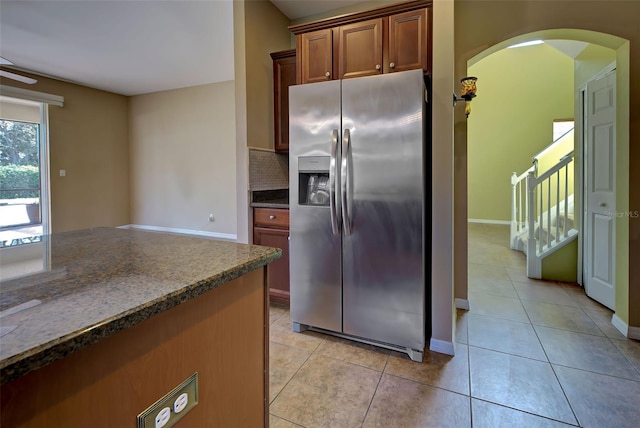 kitchen featuring tasteful backsplash, stainless steel fridge, and light tile patterned flooring