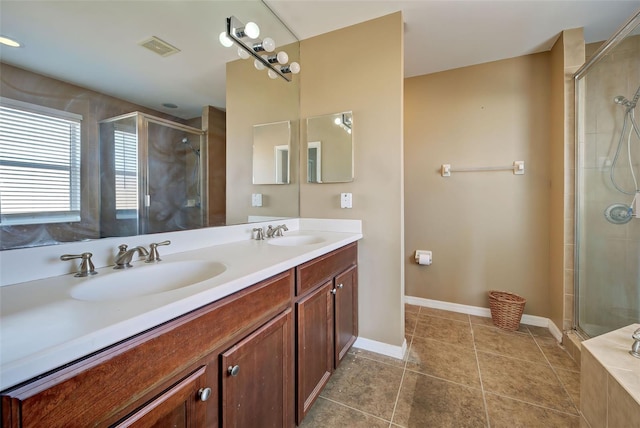 bathroom featuring tile patterned flooring, vanity, and an enclosed shower