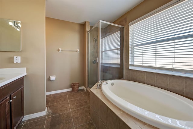 bathroom featuring tile patterned flooring, vanity, and shower with separate bathtub