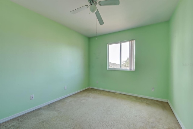 unfurnished room with ceiling fan and light carpet