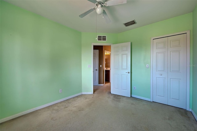 unfurnished bedroom with light carpet, a closet, and ceiling fan