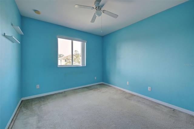 spare room featuring carpet and ceiling fan