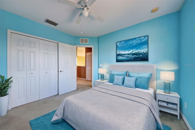 bedroom with a closet, ceiling fan, and light colored carpet