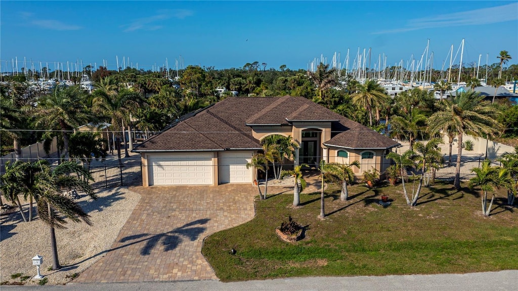 view of front of property with a garage and a front lawn