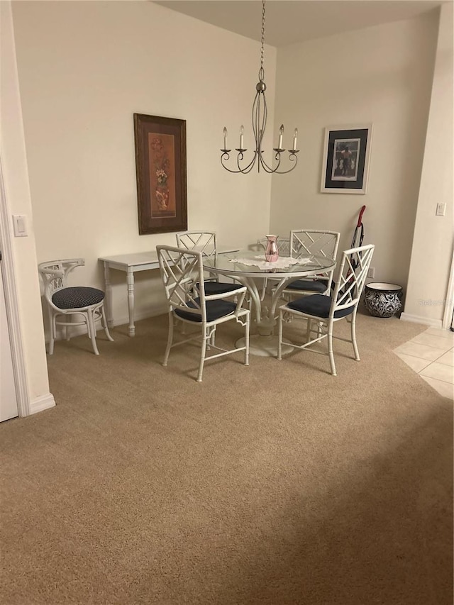 carpeted dining space featuring a chandelier