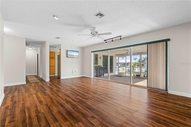 unfurnished living room with ceiling fan, dark hardwood / wood-style flooring, and a textured ceiling