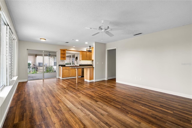 kitchen with ceiling fan, dark hardwood / wood-style flooring, and a textured ceiling