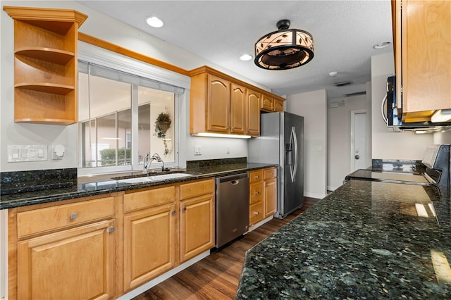 kitchen with dark hardwood / wood-style flooring, a textured ceiling, stainless steel appliances, sink, and dark stone countertops