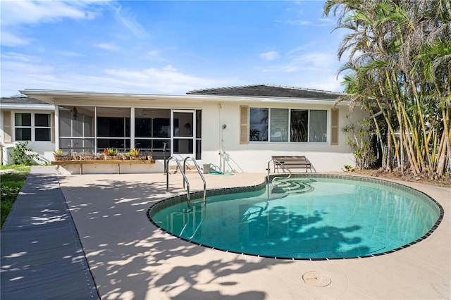 rear view of house with a patio and a sunroom