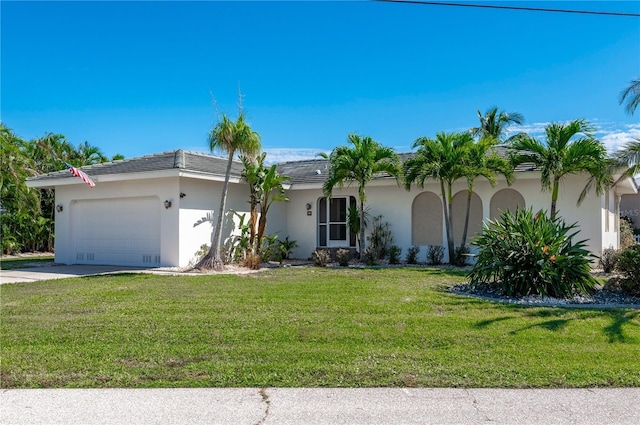 view of front of house with a front yard and a garage