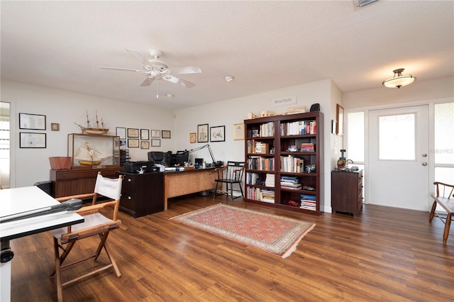 office area with dark hardwood / wood-style floors, ceiling fan, and a textured ceiling