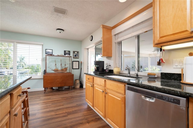 kitchen featuring dishwasher, dark stone counters, sink, a textured ceiling, and dark hardwood / wood-style flooring