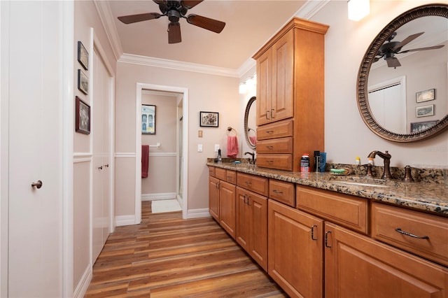 interior space featuring ceiling fan, crown molding, wood-type flooring, an enclosed shower, and vanity