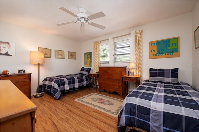 bedroom with ceiling fan and wood-type flooring