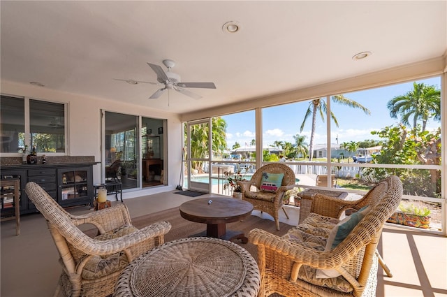 sunroom / solarium featuring ceiling fan