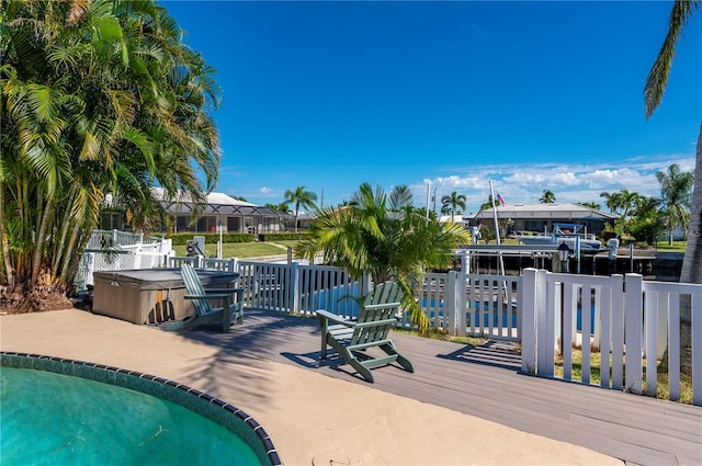 view of swimming pool with a hot tub and a deck