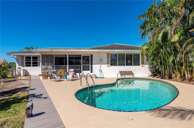 back of property featuring a sunroom and a patio