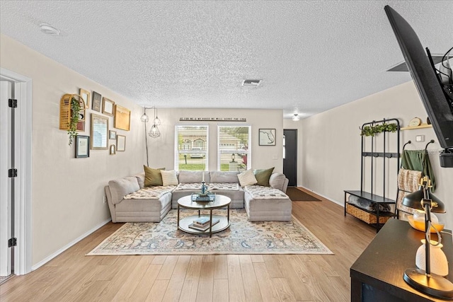 living room featuring hardwood / wood-style floors and a textured ceiling