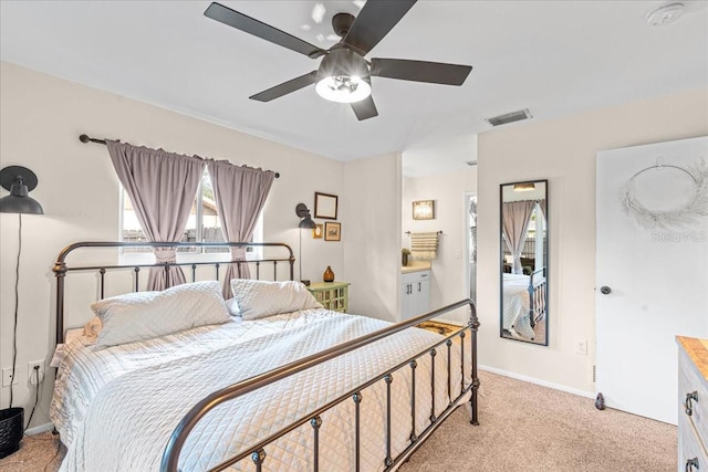 bedroom featuring light colored carpet, visible vents, baseboards, and multiple windows