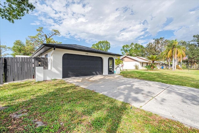 single story home with a garage and a front lawn