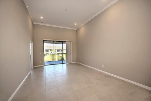 unfurnished room featuring a towering ceiling, light tile patterned floors, and ornamental molding