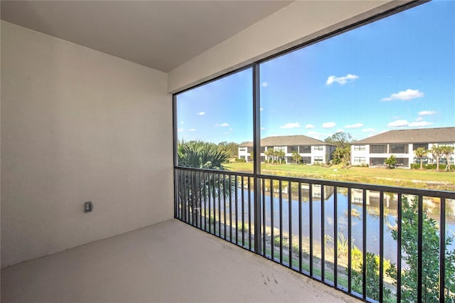 unfurnished sunroom featuring a water view and a healthy amount of sunlight