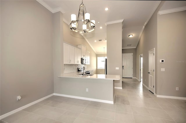 kitchen with kitchen peninsula, stainless steel appliances, and ornamental molding