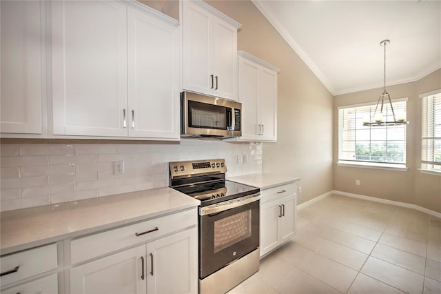 kitchen with appliances with stainless steel finishes, backsplash, white cabinetry, lofted ceiling, and light tile patterned flooring