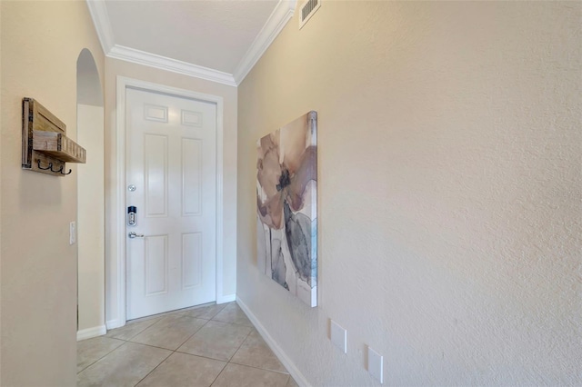 doorway to outside with light tile patterned flooring and crown molding