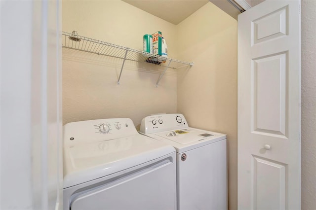 clothes washing area featuring separate washer and dryer