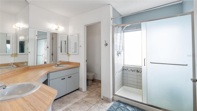 bathroom with walk in shower, tile patterned flooring, vanity, and toilet