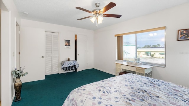 bedroom featuring ceiling fan, a closet, a textured ceiling, and dark colored carpet