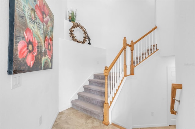 stairway featuring tile patterned flooring