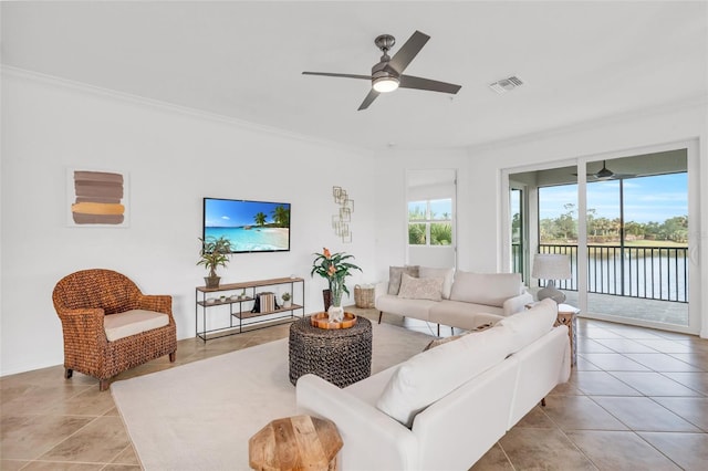 living room with ceiling fan, light tile patterned floors, and crown molding