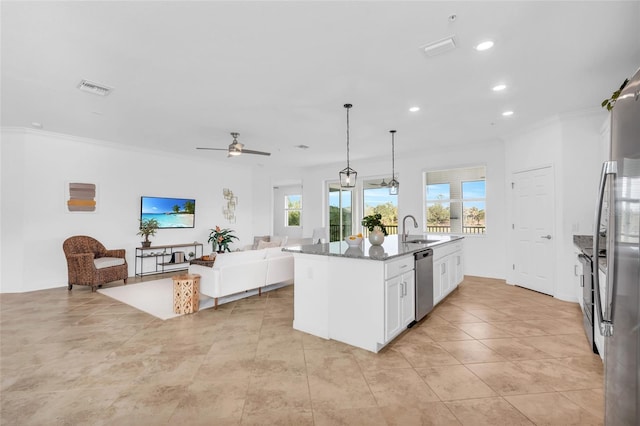 kitchen featuring white cabinetry, a center island with sink, ceiling fan, dark stone countertops, and stainless steel dishwasher