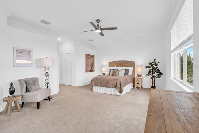 carpeted bedroom with ceiling fan and crown molding