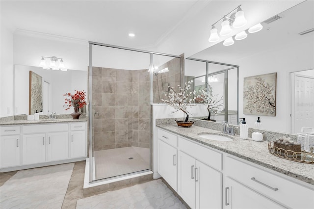 bathroom with vanity, crown molding, and walk in shower