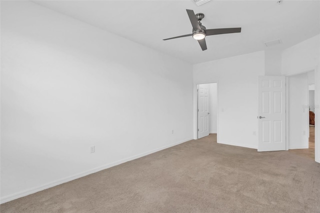 carpeted spare room featuring ceiling fan