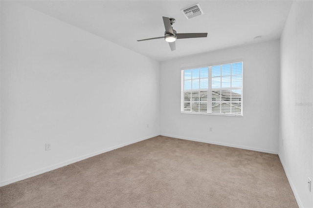 carpeted spare room featuring ceiling fan