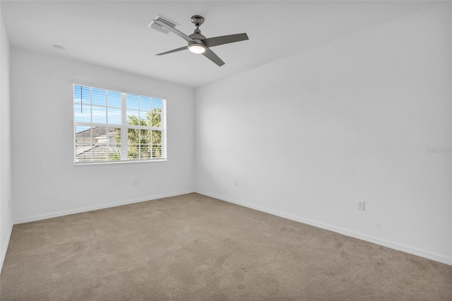 unfurnished room featuring light carpet and ceiling fan