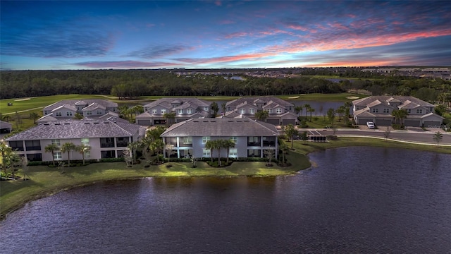 aerial view at dusk with a water view