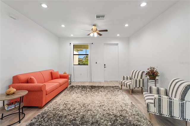 living room with hardwood / wood-style flooring and ceiling fan