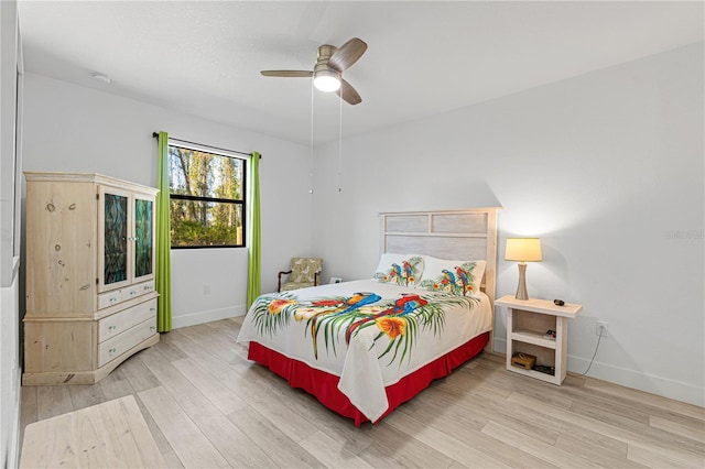 bedroom with light hardwood / wood-style floors and ceiling fan