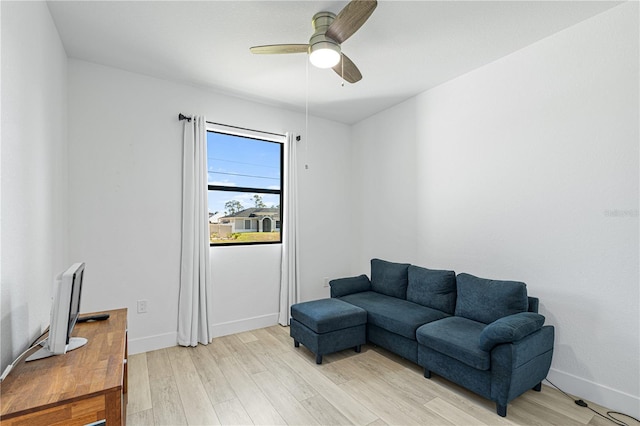 living room with ceiling fan and light hardwood / wood-style flooring