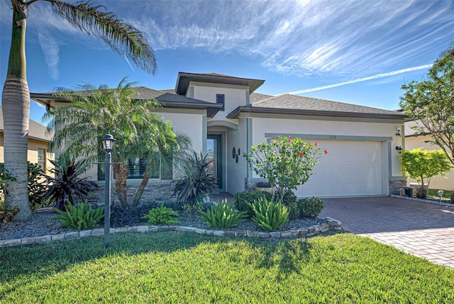 view of front of home featuring a garage and a front yard