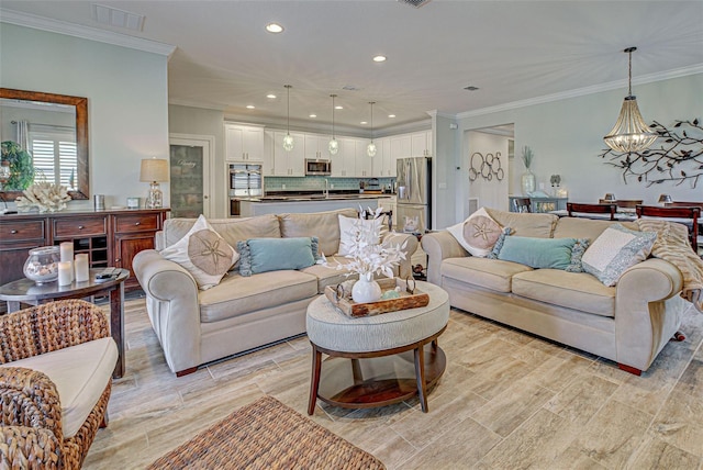 living room featuring an inviting chandelier and crown molding