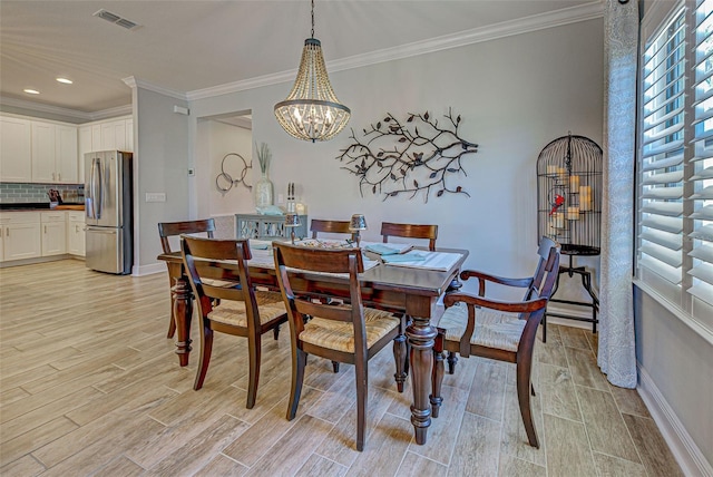 dining room featuring crown molding and a notable chandelier