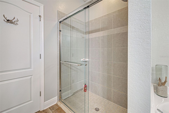 bathroom featuring a shower with door